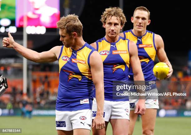 Sam Mitchell, Matt Priddis and Drew Petrie of the Eagles leave the field after their final matches during the 2017 AFL First Semi Final match between...