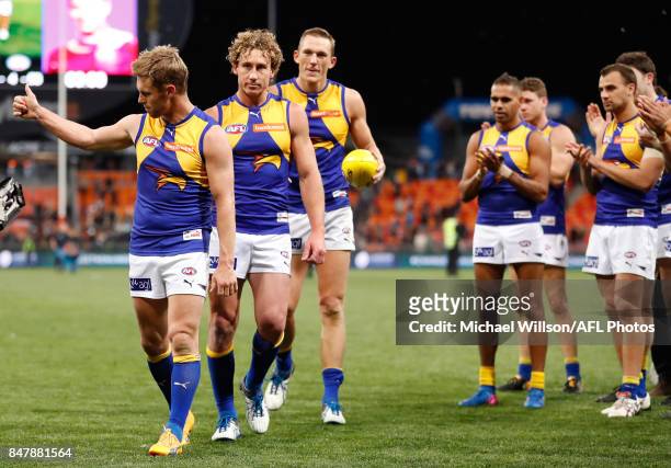 Sam Mitchell, Matt Priddis and Drew Petrie of the Eagles leave the field after their final matches during the 2017 AFL First Semi Final match between...