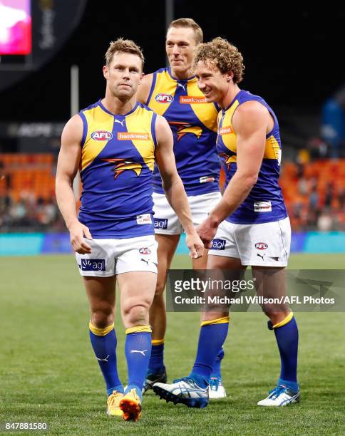 Sam Mitchell, Drew Petrie and Matt Priddis of the Eagles leave the field after their final matches during the 2017 AFL First Semi Final match between...