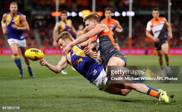 Sam Mitchell of the Eagles and Jacob Hopper of the Giants compete for the ball during the 2017 AFL First Semi Final match between the GWS Giants and...