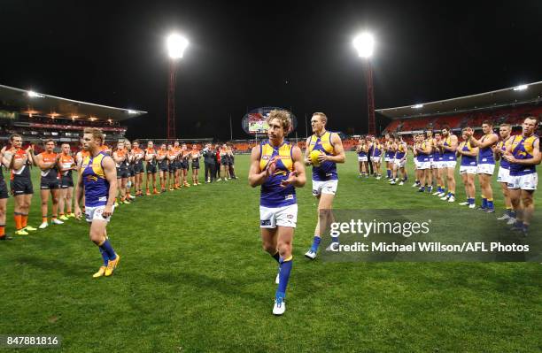 Sam Mitchell, Matt Priddis and Drew Petrie of the Eagles leave the field after their final matches during the 2017 AFL First Semi Final match between...