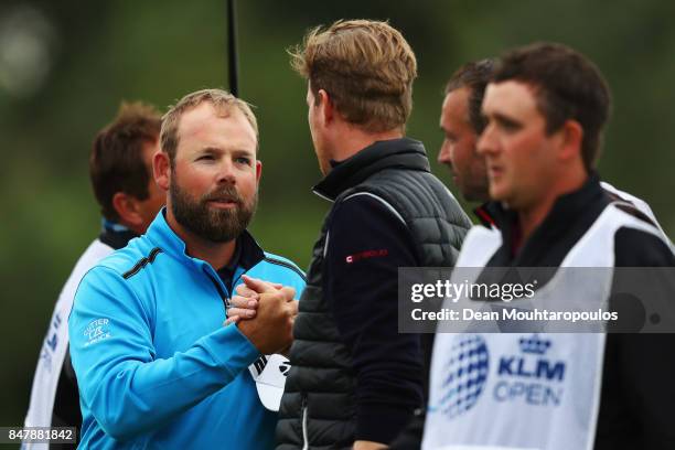 Justin Walters of South Africa shakes hands with Wil Besseling of the Netherlands on the 18th green during day 3 of the European Tour KLM Open held...