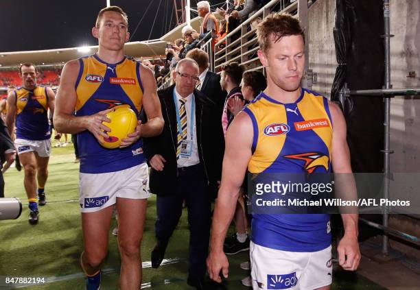 Drew Petrie and Sam Mitchell of the Eagles leave the field after their final matches during the 2017 AFL First Semi Final match between the GWS...