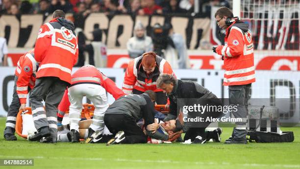 Christian Gentner of Stuttgart is being treated after a heavy foul on him by Koen Casteels of Wolfsburg during the Bundesliga match between VfB...