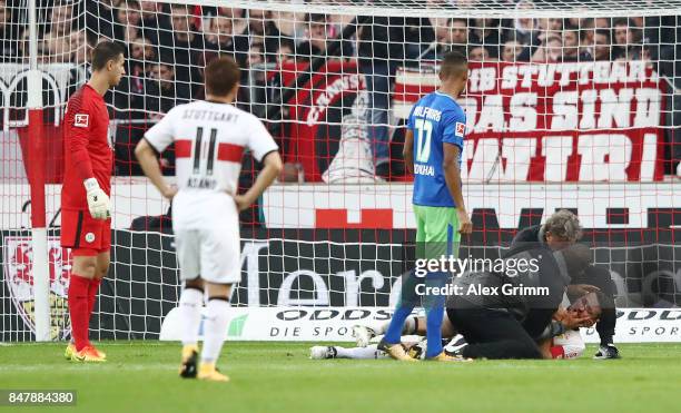 Christian Gentner of Stuttgart is being treated after a heavy foul on him by Koen Casteels of Wolfsburg during the Bundesliga match between VfB...