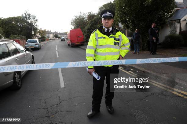 Police stand outside a property on Cavendish Road following a raid in connection with the terror attack at Parsons Green station, on September 16,...