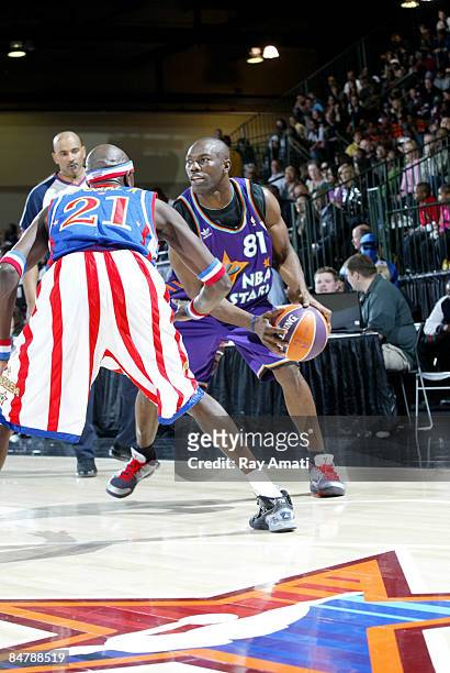 Terrell Owens of the Dallas Cowboys dribbles against Special K Daley of the Harlem Globetrotters during the McDonald's All-Star Celebrity Game on...