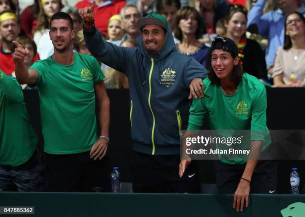 Nick Kyrgios, Thanasi Kokkinakis and Alexei Popyrin of Australia celebrate a point as John Peers and Jordan Thompson of Australia play in the doubles...