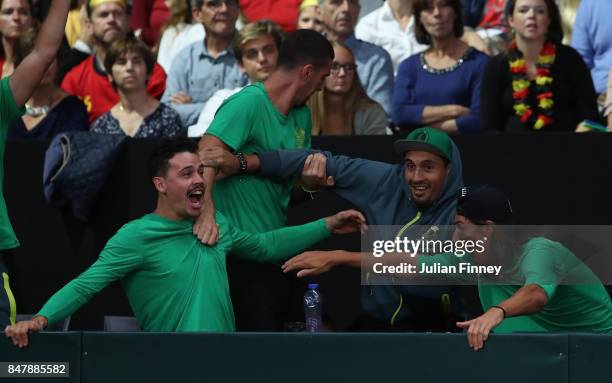 Nick Kyrgios, Thanasi Kokkinakis and Alexei Popyrin of Australia celebrate a point as John Peers and Jordan Thompson of Australia play in the doubles...