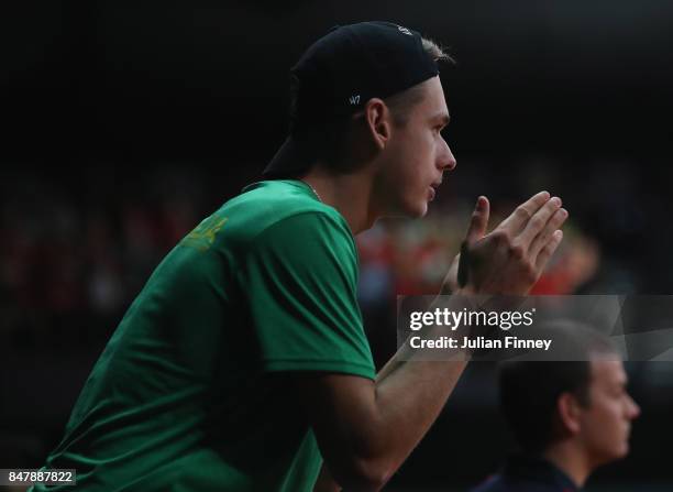 Alex De Minaur of Australia gives his support for John Peers and Jordan Thompson of Australia in their doubles match against Ruben Bemelmans and...