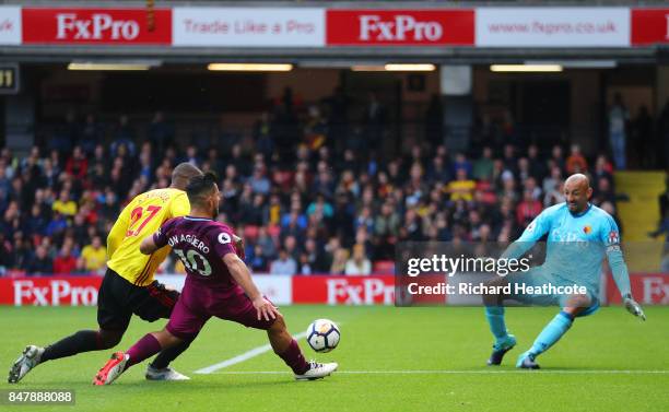 Sergio Aguero of Manchester City scores his sides fifth goal past Heurelho Gomes of Watford while under pressure from Christian Kabasele of Watford...
