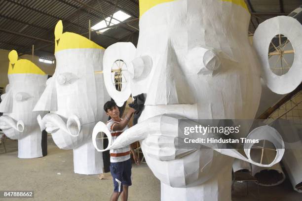 Muslim artist from western UP works for the Hindu festival of Dusshehra and prepares effigies ahead of Dussehra festival in various Ramlilas across...