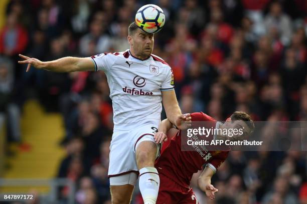 Burnley's Welsh striker Sam Vokes vies with Liverpool's Scottish defender Andrew Robertson during the English Premier League football match between...