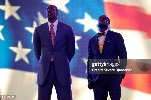 Assistantcoach Dwight Howard of the Sophomore team and assistant coach Dwyane Wade of the Rookie team stand during the anthem before the T-Mobile...