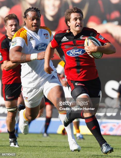 Tim Bateman of the Crusaders makes a break to score a try during the round one Super 14 match between the Crusaders and the Chiefs at AMI Stadium on...
