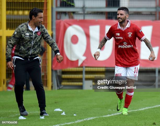 Cristian Buonaiuto of Perugia Calcio celebrates with Federico Giunti head coach of Perugia Calcio after scoring a goal to make it 3-0 during the...