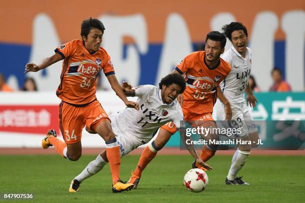 Leandro of Kashima Antlers is challenged by Teruki Hara of Albirex Niigata during the J.League J1 match between Albirex Niigata and Kashima Antlers...