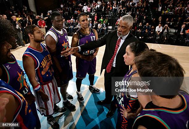 Legend Julius Erving talks to Handles Franklin of the Harlem Globetrotters, and NBA Legends Dominique Wilkins and Rick Fox during the McDonald's...