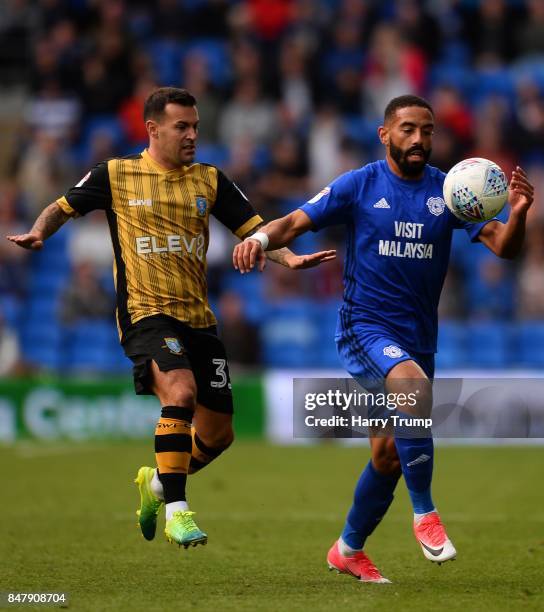 Liam Feeney of Cardiff City is tackled by Ross Wallace of Sheffield Wednesday during the Sky Bet Championship match between Cardiff City and...