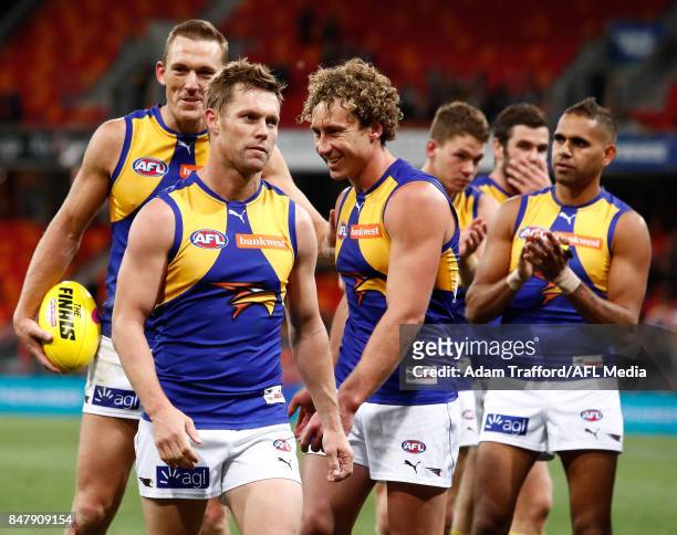 Sam Mitchell , Drew Petrie and Matt Priddis of the Eagles leave the field after their final match during the 2017 AFL First Semi Final match between...