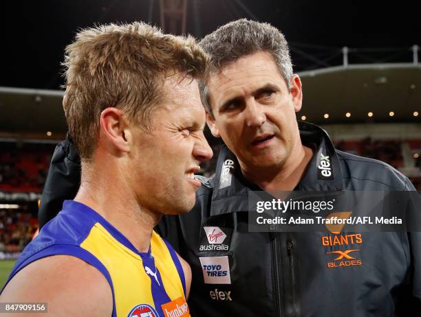 Leon Cameron, Senior Coach of the Giants congratulates Sam Mitchell of the Eagles after his last game during the 2017 AFL First Semi Final match...