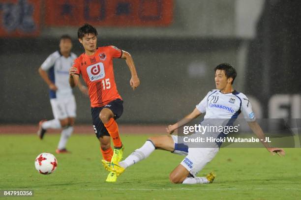 Keisuke Oyama of Omiya Ardija is tackled by Shun Nagasawa of Gamba Osaka during the J.League J1 match between Omiya Ardija and Gamba Osaka at...