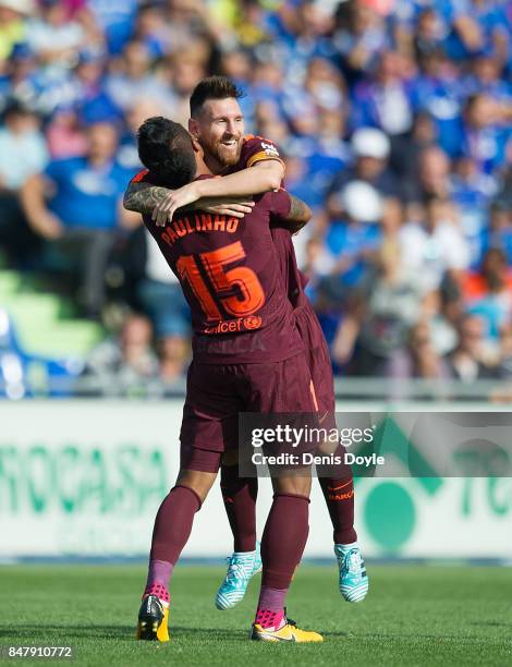 Paulinho of FC Barcelona celebrates with Lionel Messi after scoring his team's 2nd goal during the La Liga match between Getafe and Barcelona at...