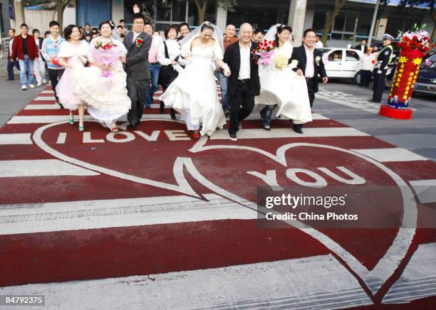 Newlyweds cross over a "Love Zebra Crossing" on February 14, 2009 in Chengdu, Sichuan Province, China. Valentine's Day has become one of the most...