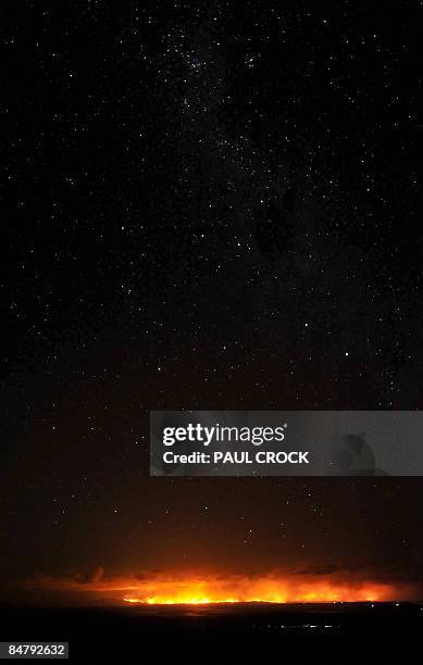 The Southern Cross constellation of stars are seen above a ferocious 10km firefront of the Wilson's Promontory - Cathedral wildfire which, started by...