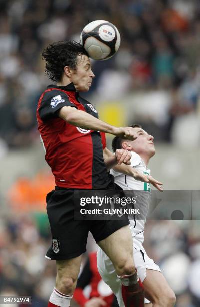 Fulham's Welsh player Simon Davies heads the ball under a challenge from Swansea's Joe Allen during their F.A Cup fifth round match at The Liberty...