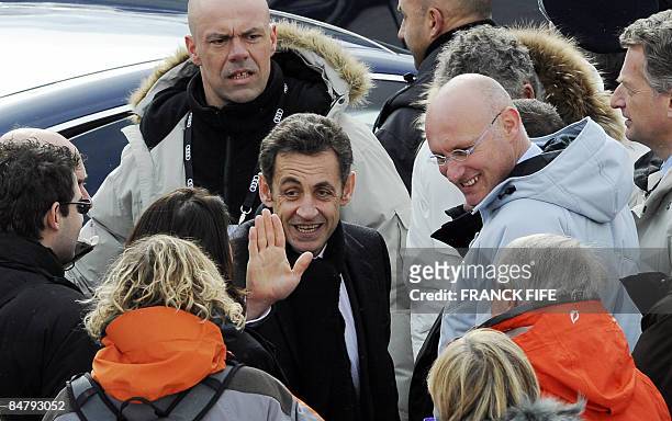 French President Nicolas Sarkozy waves next to French Secretary of State for Sport, Bernard Laporte as he leaves after the women's slalom at the...