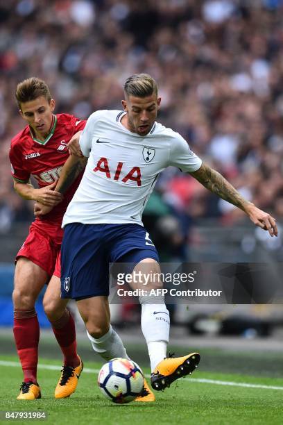 Swansea City's English midfielder Tom Carroll vies with Tottenham Hotspur's Belgian defender Toby Alderweireld during the English Premier League...