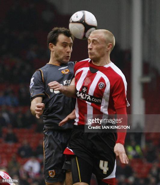 Hull City's Australian footballer Richard Garcia challenges Sheffield United's David Cotterill during their FA Cup fifth round football match at...
