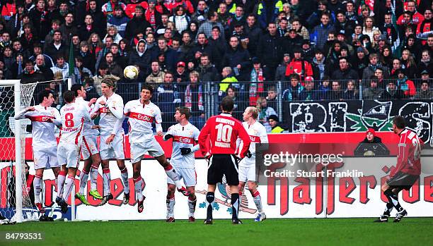 Jacek Krzynowek of Hannover shoots the ball over a wall of players of Stuttgart to score the second goal during the Bundesliga match between Hannover...