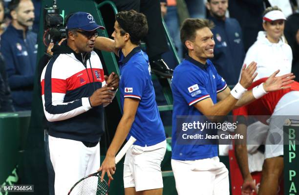 Nicolas Mahut and Pierre-Hugues Herbert of France celebrate with captain Yannick Noah winning the doubles match against Serbia on day two of the...