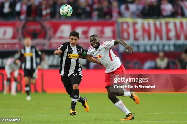 Dayot Upamecano of Leipzig fights for the ball with Jonas Hofmann of Moenchengladbach during the Bundesliga match between RB Leipzig and Borussia...