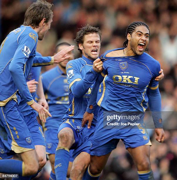 Glen Johnson of Portsmouth celebrates scoring the first goal with teammate Hermann Hreidarsson during the Barclays Premier League match between...