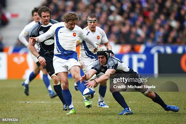 Cedric Heymans of France kicks ahead despite the attention of Kelly Brown during the RBS 6 Nations match between France and Scotland at the Stade de...