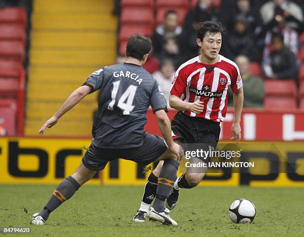 Sheffield United's Chinese player Sun Jihai goes past Hull City's Australian footballer Richard Garcia during their FA Cup fifth round football match...