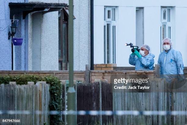 Forensics officers investigate a property on Cavendish Road during a raid in connection with the terror attack at Parsons Green station on September...