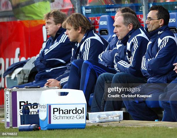 Assistant coach Mike Bueskens, assistant coach Youri Mulder and manager Andreas Mueller of Schalke sit on the bench during the Bundesliga match...