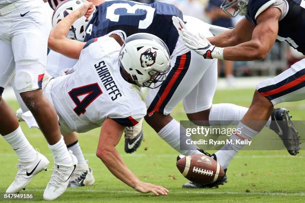 Bryant Shirreffs of the Connecticut Huskies loses a fumble during a game against the Virginia Cavaliers at Scott Stadium on September 16, 2017 in...