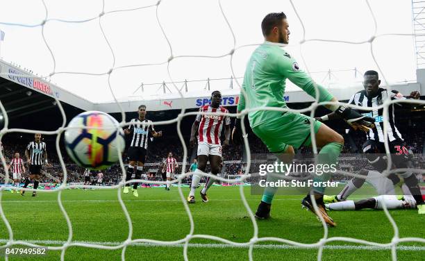 Newcastle player Christian Atsu scores the opening goal past Jack Butland during the Premier League match between Newcastle United and Stoke City at...