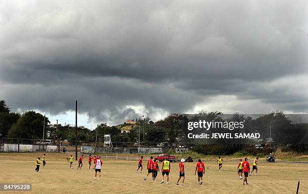 Black cloud hovers over the field where England's cricketers practice in St John's on February 14, 2009. West Indies and England hope the conditions...