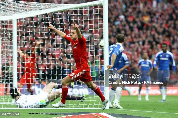 Liverpool's Andy Carroll runs off in celebration as he beleives that he has scored their second goal of the game, only to see the effort ruled out by...