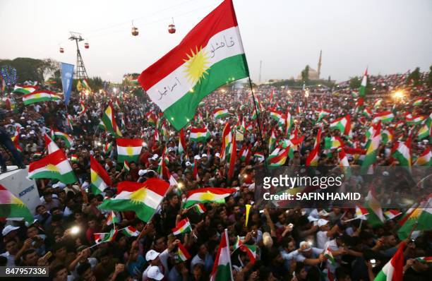 Iraqi Kurds fly Kurdish flags during an event to urge people to vote in the upcoming independence referendum in Arbil, the capital of the autonomous...