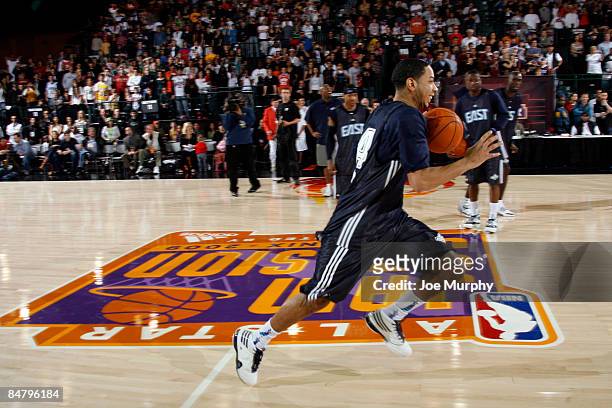 Devin Harris of the East All-Stars tries to beat the Guinness World Record for fastest dribbling from base line to base line during the East...