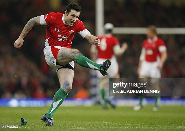 Wales' fly half Stephen Jones watches his penalty kick go through the posts during the Six Nations rugby match at the Millennium Stadium in Cardiff...