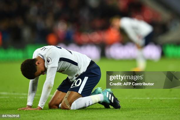 Tottenham Hotspur's English midfielder Dele Alli sinks to his knees at the final whistle in the English Premier League football match between...