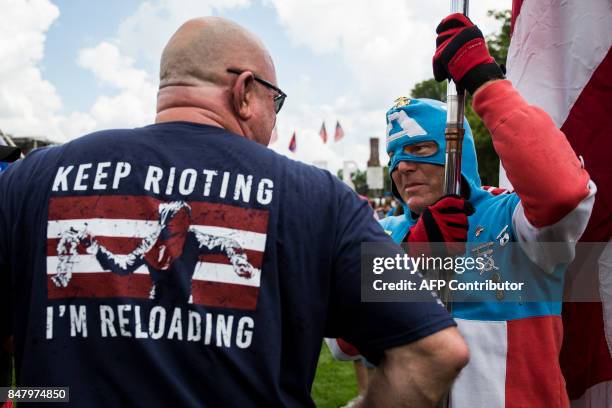 Man dressed as Captain America speaks to a demonstrator during the pro-Trump 'Mother of All Rallies' held on the National Mall in Washington, DC on...